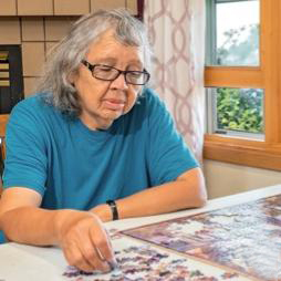 Elder women completing a puzzle.