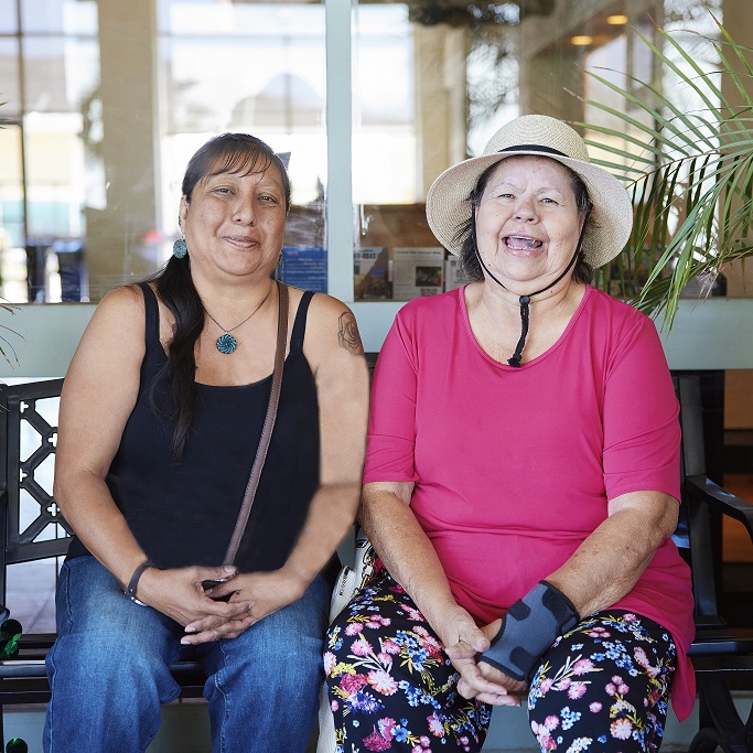 women sitting on a bench
