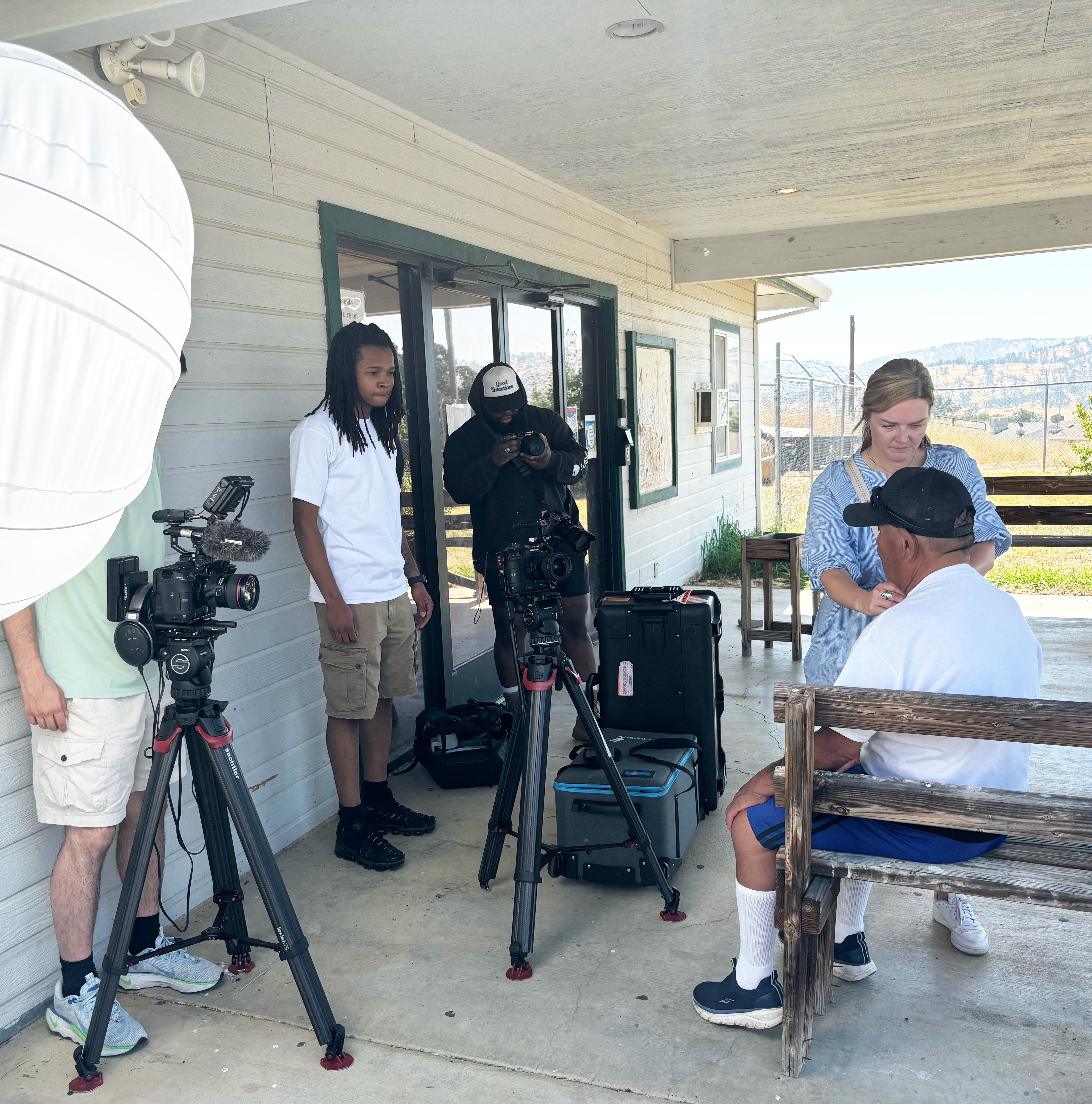 People on a porch shooting a video