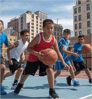 A group of Native youth playing basketball