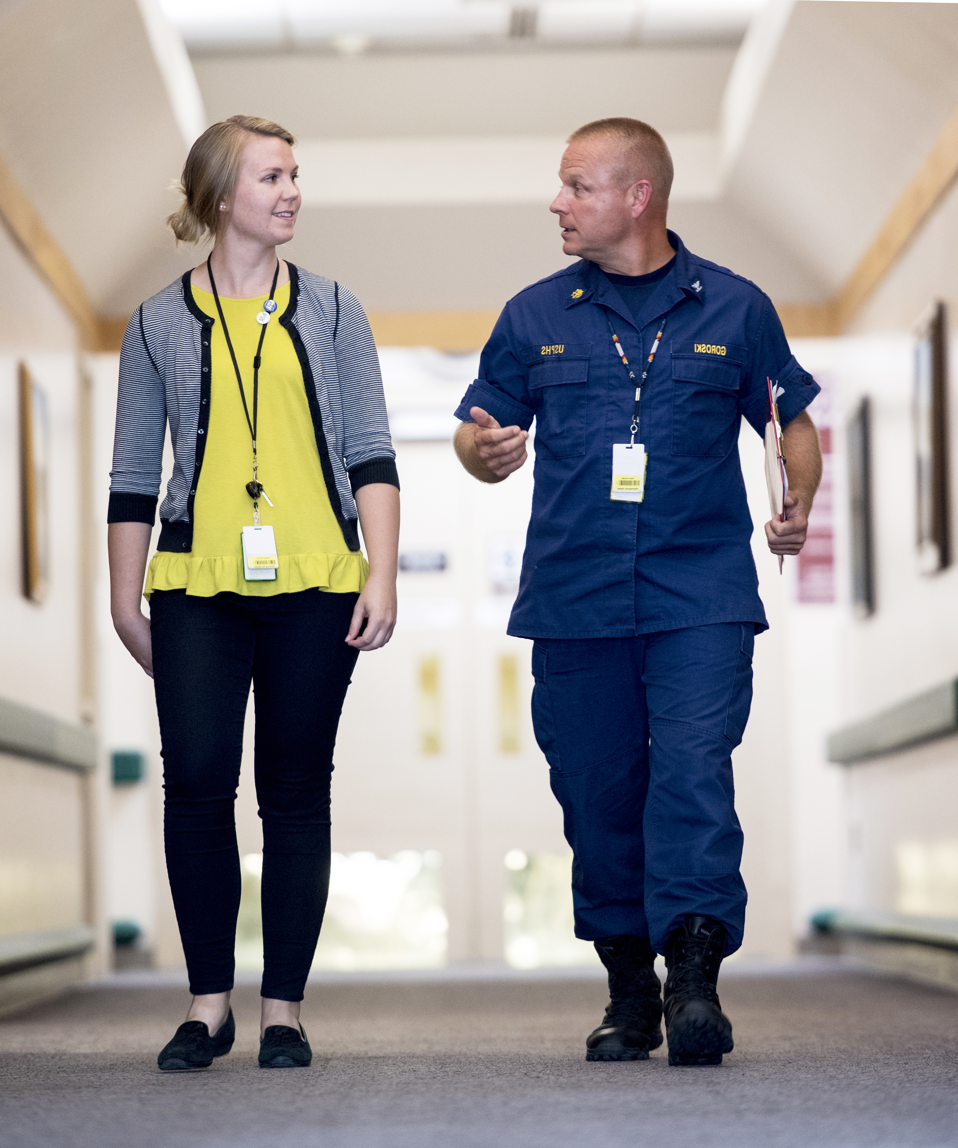 two people walking down a hallway