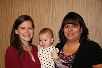 Thumbnail - clicking will open full size image - Kristen Krane and her child, with Supervisory Clinical Nurse Charlene Ramirez, Obstetrics/Inpatient Ward at Blackfeet Clinical Hospital